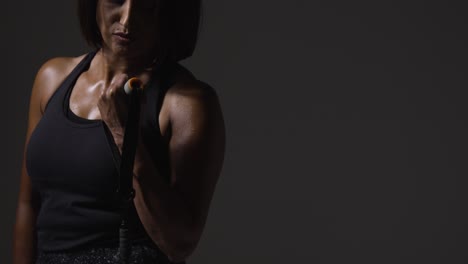 Close-Up-Studio-Shot-Of-Mature-Woman-Wearing-Gym-Fitness-Clothing-Exercising-With-Resistance-Band-3