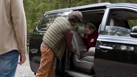 family getting ready to travel on big car