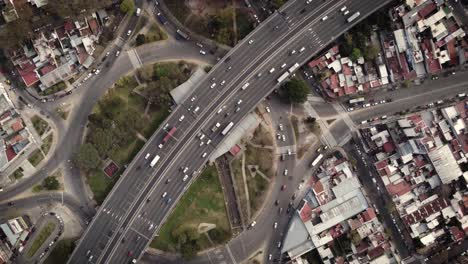 una toma aérea estacionaria de lapso de tiempo de tráfico pesado por encima y por debajo del paso elevado