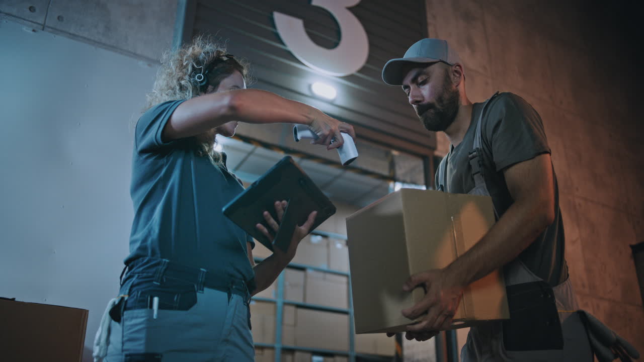 Multiethnic Workers Loading Cardboard Boxes with Online Orders in Truck Working at Night