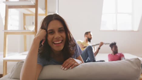 Beautiful-woman-smiling-while-sitting-on-the-couch