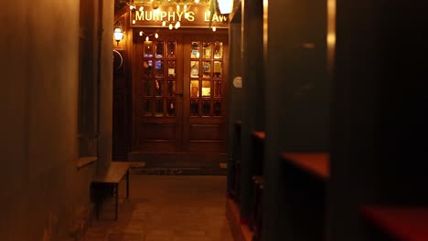 dimly lit alleyway leading to murphy's law restaurant