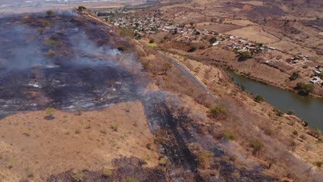 helicopter firefighting forest fire blaze on la huasteca mexico dry grass hillside