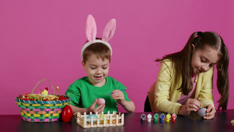 young adorable kids coloring easter eggs with watercolor paint