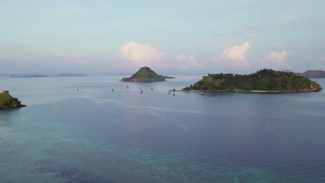 beautiful komodo archipelago islands in indonesia sea - aerial drone flight at sunset