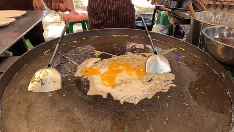 sequence of frying eggs on a large griddle.