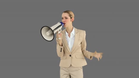 bossy businesswoman shouting through megaphone