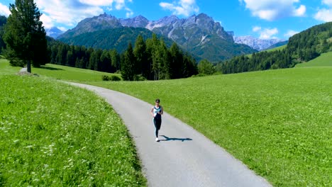 woman jogging outdoors. italy dolomites alps