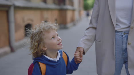 child walking to school with mother