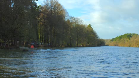 a wooden boat sailing across the pond in etang saint nicolas in angers, france