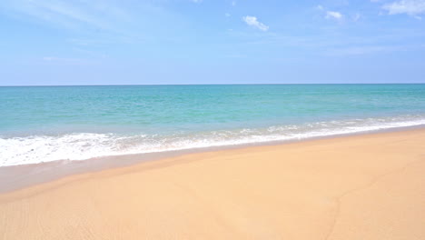 foamy little sea waves crashing and splashing over soft yellow sandy beach, nature background