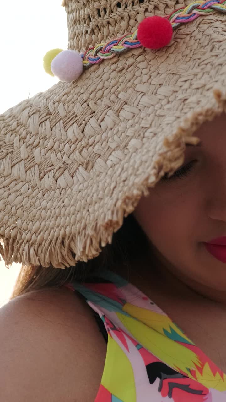 Woman wearing a straw hat and swimsuit