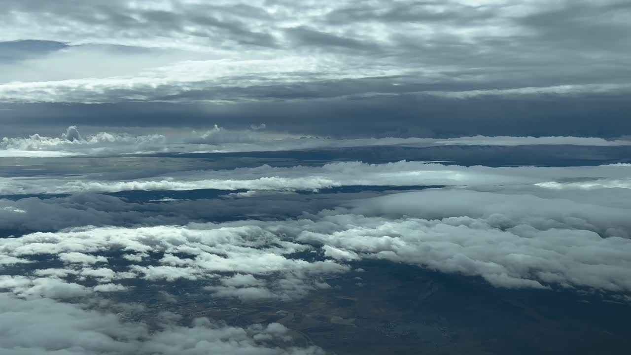 Pilot’s POV FPV during a real time flight through layers of grey clouds in a dramatic winter sky. Aerial footage taken from an airplane cockpit, as seen by the pilots. 4K 60FPS