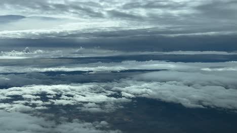pilot’s pov fpv during a real time flight through layers of grey clouds in a dramatic winter sky. aerial footage taken from an airplane cockpit, as seen by the pilots. 4k 60fps