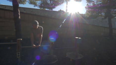 A-guy-doing-push-ups-in-a-green-sunny-yard