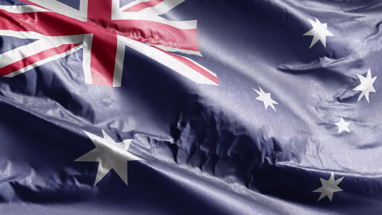 bandera textil de australia ondeando en el bucle del viento. bandera australiana balanceándose en la brisa. tejido textil de tela. fondo de relleno completo. bucle de 10 segundos.