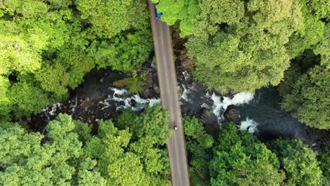 drone focusing road bridge with vehicles crossing in tropical atmosphere