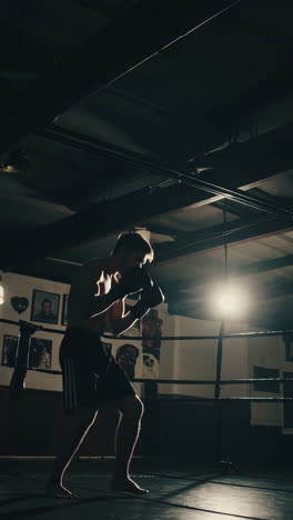 man boxing training in gym at night