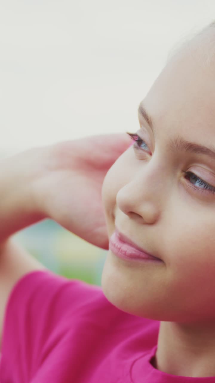 A Young Girl Enjoying Music Through Pink Headphones, Capturing the Joy of Listening as She Engages Emotionally with Her Favorite Tunes in a Relaxed Atmosphere