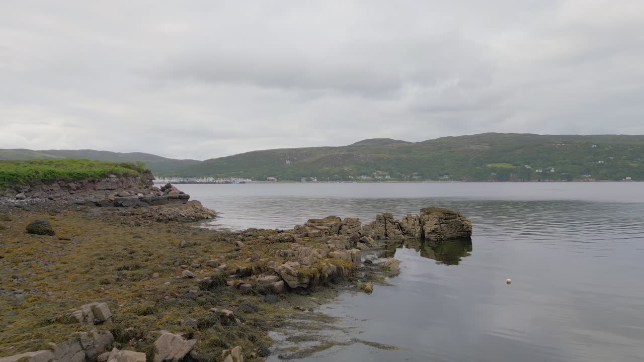 Abandoned fishing boats on the rocky shoreline of Loch Broom, Scottish Highlands