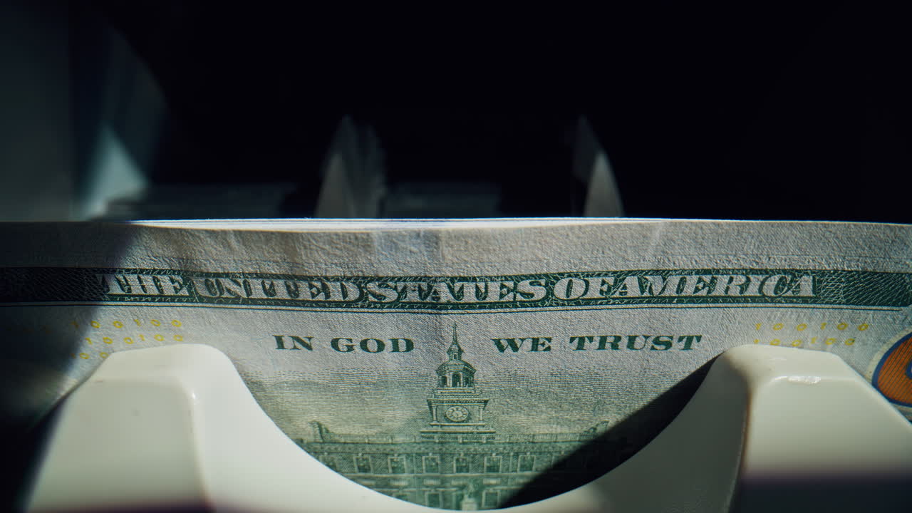 Closeup bank machine working with paper cash dollars inside modern office fast