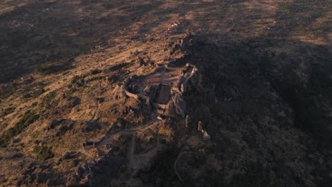 epic aerial view over monsanto fortress ruins at sunrise, portugal