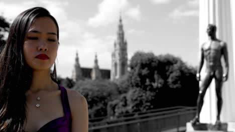 asian woman in color, vienna townhall and statue in black and white, selective color technique, sunny day