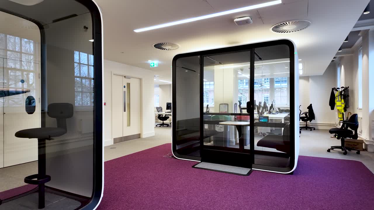 Comfortable soundproof office pods guaranteeing privacy and concentration in a modern open space office