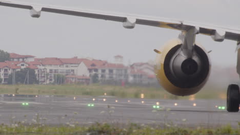 airplane taxiing on runway in cloudy weather