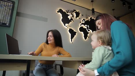 a mother and daughter choose a vacation ticket at a travel agency. travel concept