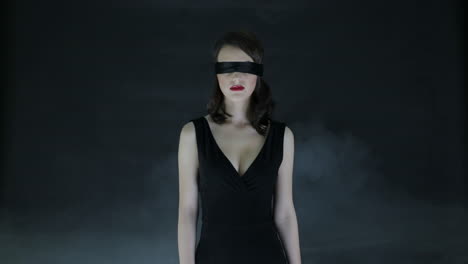 blindfolded woman in black dress