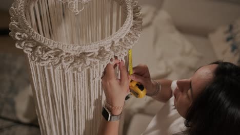 home hobby, knitting macrame. women's hands knit an ornament with thick threads.