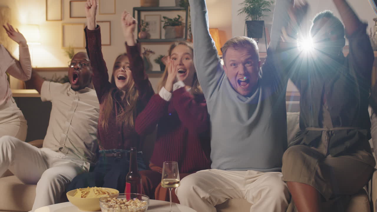 Slowmo of Young People Cheering while Watching Movie