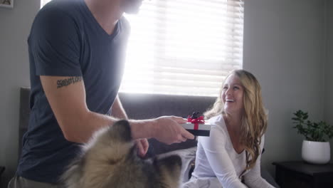 a man surprising his wife with a gift