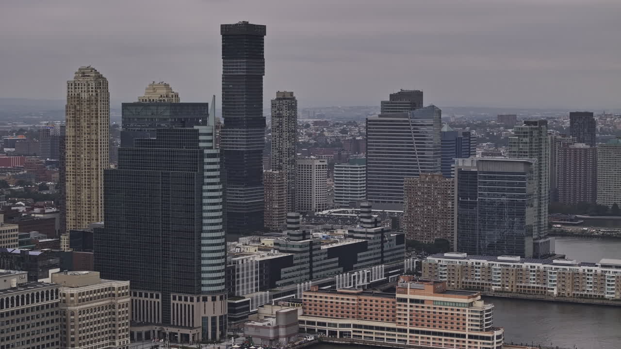 Jersey City New Jersey Aerial v24 zoomed flyover Hudson river capturing waterfront downtown cityscape of a mix of commercial and residential developments - Shot with Mavic 3 Pro Cine - September 2023