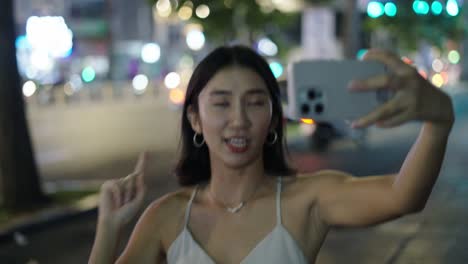 Young Woman Taking a Selfie at Night