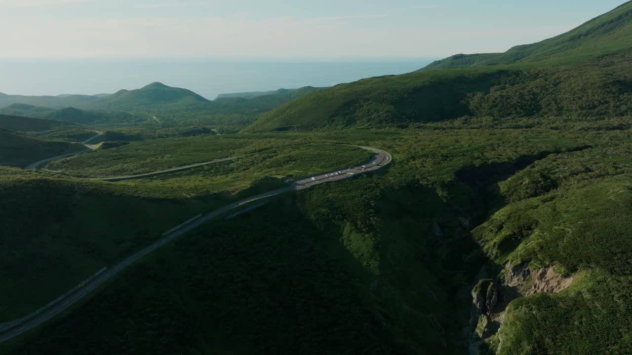 Scenic View Of Shiretoko Pass - Winding Mountain Road Near Mount Rausu In Hokkaido, Japan. wide aerial shot