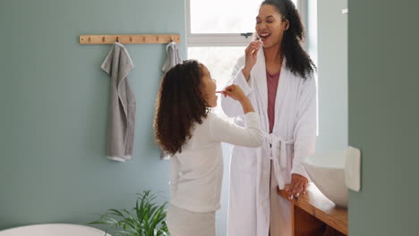 mother and daughter brushing teeth