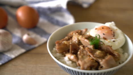 stir-fried pork with garlic on topped rice with egg - asian food style