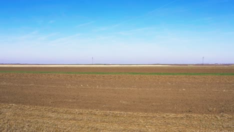 Aerial-view-drone-footage-of-plowed-agricultural-field