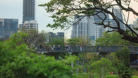 a stationary time-lapse footage of a tourist footbridge located at the benchasiri park, bangkok