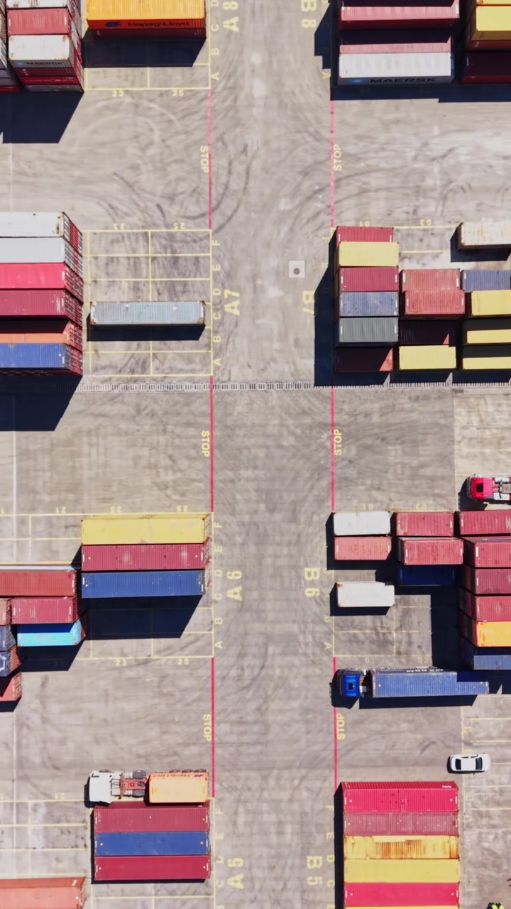 Cargo containers arranged in a busy freight yard during daytime