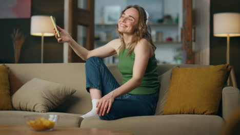 Excited-lady-dancing-couch-place.-Happy-woman-enjoying-active-music-falling-sofa