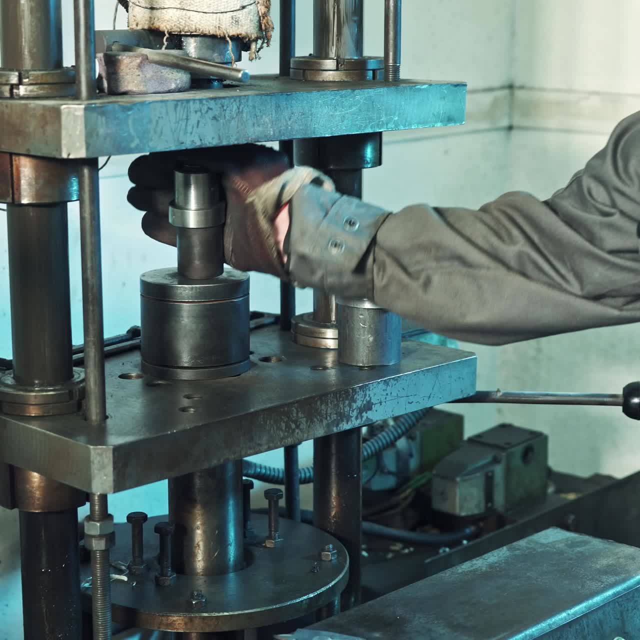 Man operating hydraulic press