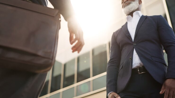 Handshake, welcome and business people in city