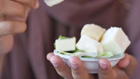 woman eating cheese cubes