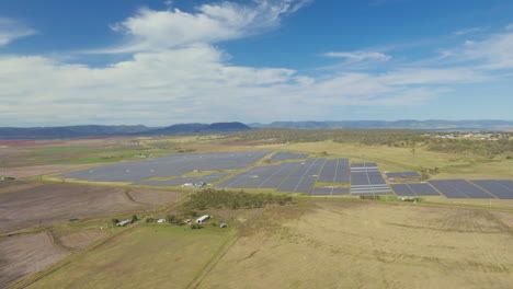 large solar farm generating power in countryside rural australia, 4k wide angle drone aerial