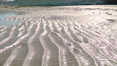 bright wet desert beach of patagonia in summer -tilt up