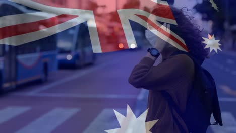 australian flag waving against woman wearing face mask