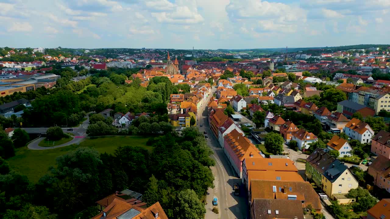 4K Aerial Drone Video of the St. Johannis Kirche Church along the Frankische Rezat River in Downtown Ansbach, Germany